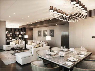 a dining room with a table and a living room at The Okura Prestige Bangkok in Bangkok