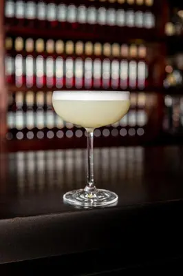 a glass of white drink sitting on a counter at The Okura Prestige Bangkok in Bangkok