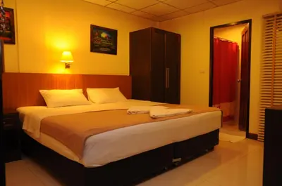 a bedroom with a large bed with two towels on it at Lodge 61 Hotel in Bangkok