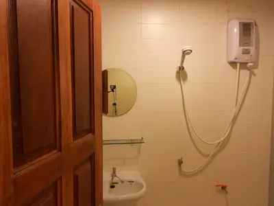 a bathroom with a shower and a sink at Lodge 61 Hotel in Bangkok