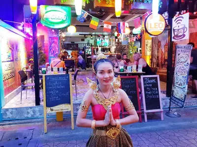 a girl in a dress standing in front of a restaurant at Casa Picasso Near Chabad House in Bangkok