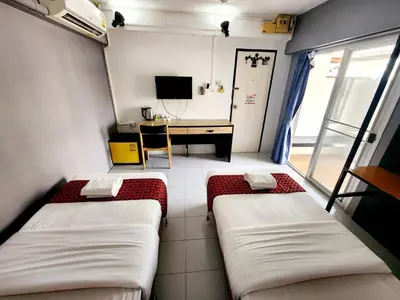 a small room with two beds and a desk at Casa Picasso Near Chabad House in Bangkok