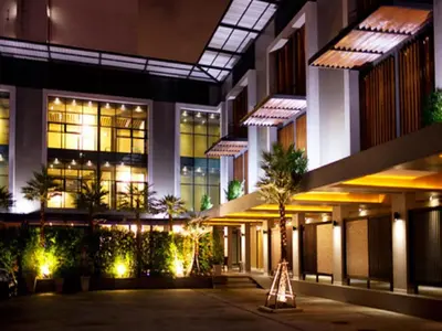a building at night with a sign in front of it at Siam Swana in Bangkok
