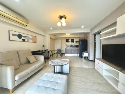a living room with a couch and a table at Baan Sabai Rama IV Apartment in Bangkok