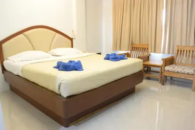 a bedroom with a bed with blue bows on it at At Bangkok Hotel in Bangkok