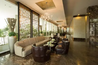 a lobby with a couch and chairs and windows at Ivy Thonglor 55 in Bangkok