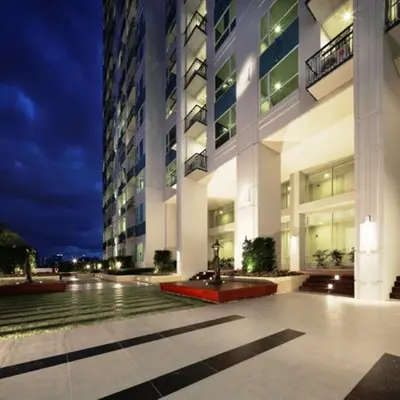 a large building with a fountain in front of it at Ivy Thonglor 55 in Bangkok