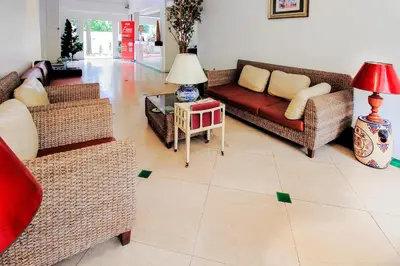 a living room with couches and a table at Royal Pimand Hotel in Bangkok