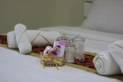 a table with towels and a tray withentedented candles and a candle holder at Be My Guest 36 in Bangkok