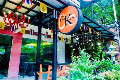 a restaurant with a sign on the side of a building at The Konnect Hotel in Bangkok