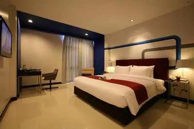 a hotel room with a large bed and a desk at FX Hotel Metrolink Makkasan in Bangkok
