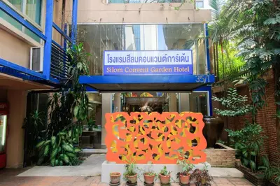 a sign in front of a building with plants at Silom Convent Garden in Bangkok