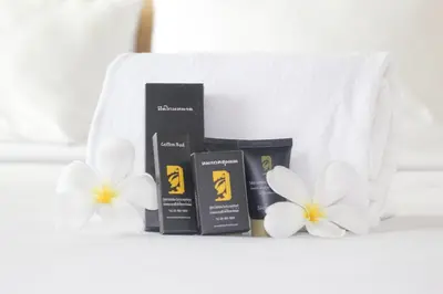 a pile of products sitting next to white flowers at Bansabai Sabaidee Service Apartment in Bangkok