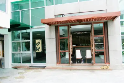 an entrance to a building with glass windows at Bansabai Sabaidee Service Apartment in Bangkok