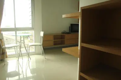 a kitchen with a table and chairs and a window at Bansabai Sabaidee Service Apartment in Bangkok