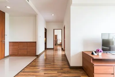 a hallway of a house with white walls and wooden floors at Bangkok Patio BTS Sanam Pao in Bangkok