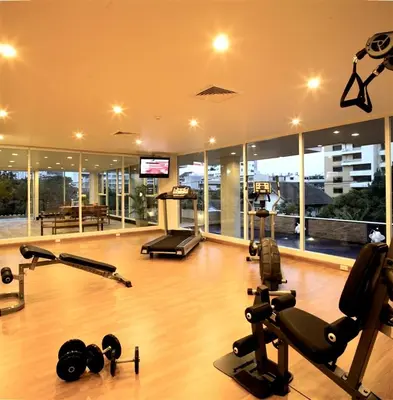a gym with several exercise equipment in a building at Bangkok Patio BTS Sanam Pao in Bangkok