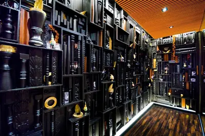 a room filled with lots of books on shelves at Tongtara Riverview Hotel in Bangkok