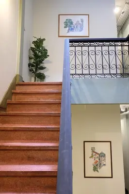 a set of stairs in a building with a blue railing at The Orientale Hostel in Bangkok