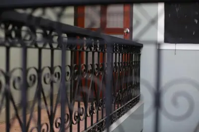 a black fence with a bunch of scissors at The Orientale Hostel in Bangkok