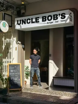 a man standing in the doorway of a building at The Orientale Hostel in Bangkok