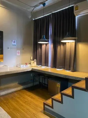 a room with a long desk with two lights at Yaksa Private in Bangkok