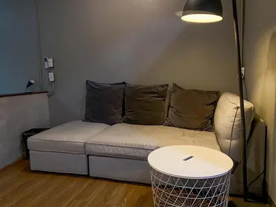 a living room with a couch and a table at Yaksa Private in Bangkok