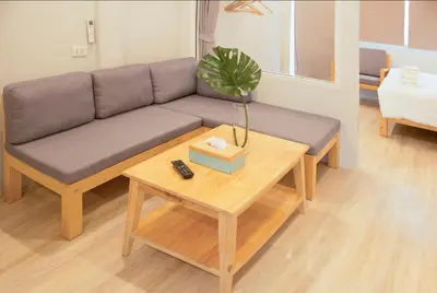 a living room with a couch and a table at Ekanake hostel in Bangkok