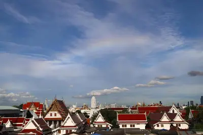 a group of roofs of houses under a cloudy sky at Ekanake hostel in Bangkok