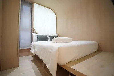 a bedroom with a large bed with a window at W 21 Hotel Bangkok in Bangkok
