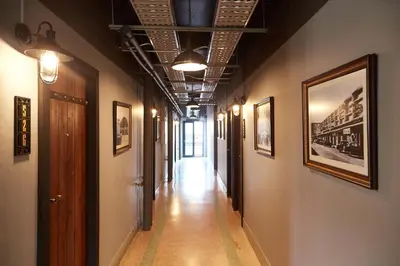 a long hallway with paintings on the walls at W22 by Burasari in Bangkok