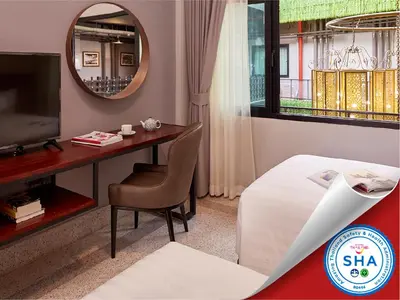 a bedroom with a desk and a bed and a mirror at W22 by Burasari in Bangkok