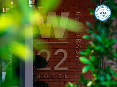 a sign on a brick wall with the number two at W22 by Burasari in Bangkok