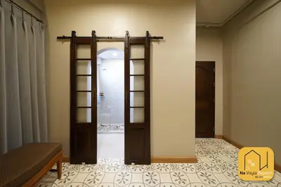 a room with a door and a room with a bed at Na Vayla PaPlern in Bangkok