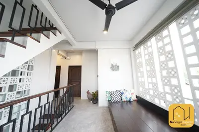 a hallway of a house with a staircase and windows at Na Vayla PaPlern in Bangkok