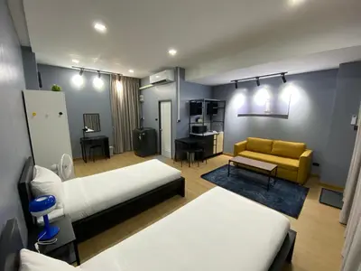 a living room with two beds and a couch at Bangyai Inn-private room in Nonthaburi