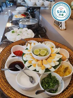 a tray with plates of food on a table at S Bangkok Hotel, Navamin in Ban Khi Sua