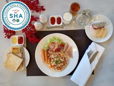 a table with a plate of food on a table at S Bangkok Hotel, Navamin in Ban Khi Sua