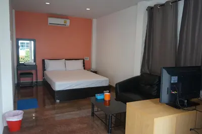a small room with a bed and a television at 58 Ville Resort in Bangkok