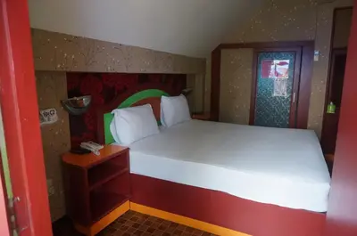a small bedroom with a bed and a window at 58 Ville Resort in Bangkok
