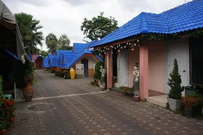 a row of houses with blue roofs on a street at 58 Ville Resort in Bangkok