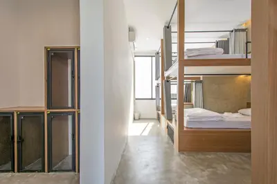 two bunk beds in a room with a bedroom at Lost Inn BKK in Bangkok
