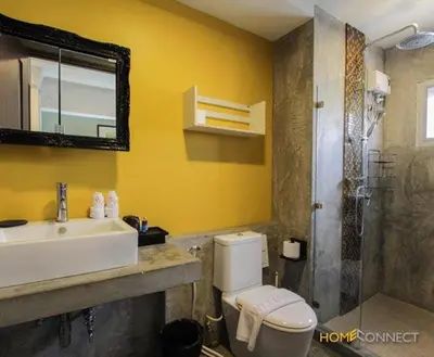 a bathroom with a sink and a toilet and a shower at T Series Place Serviced Apartment in Bangkok