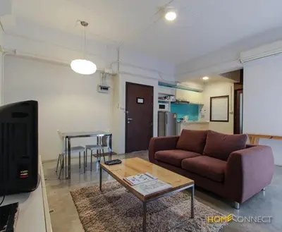 a living room with a couch and a table at T Series Place Serviced Apartment in Bangkok