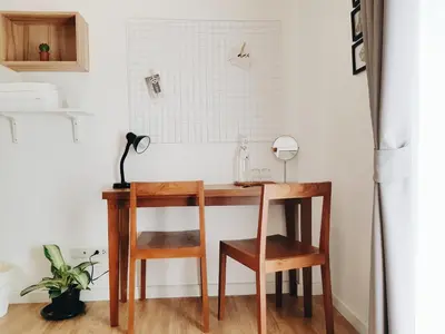 a table and two chairs and a desk in a room at LITA Bangkok in Bangkok