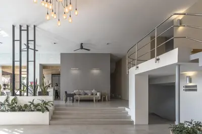 a living room with a staircase and a couch at Carnation Residence in Samut Prakan