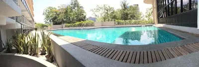a large swimming pool in the middle of a building at Carnation Residence in Samut Prakan
