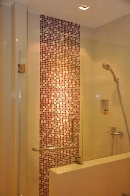 a bathroom with a shower with a glass door at Iyarin @ Tuk Chang Hotel in Bangkok