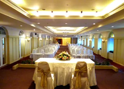 a large banquet hall with white tables and chairs at Iyarin @ Tuk Chang Hotel in Bangkok
