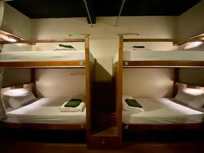 a room with three bunk beds in a room at Suneta Hostel Khaosan in Bangkok